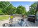 Outdoor deck featuring a dining table, chairs, and a grill for outdoor cooking at 369 Arnold Mill Rd, Woodstock, GA 30188