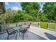 Spacious outdoor deck with table and chairs, perfect for enjoying the lush backyard view at 369 Arnold Mill Rd, Woodstock, GA 30188