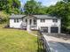 Charming white two-story home with manicured lawn and an inviting front porch and 2-car garage at 369 Arnold Mill Rd, Woodstock, GA 30188