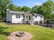 Inviting home featuring an outdoor fire pit and nicely landscaped yard and 2 car garage at 369 Arnold Mill Rd, Woodstock, GA 30188