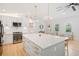 Bright kitchen with white cabinets, stainless steel appliances, and large island at 369 Arnold Mill Rd, Woodstock, GA 30188