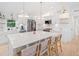 Modern kitchen with a large island, stylish pendant lighting, stainless appliances, and hardwood floors at 369 Arnold Mill Rd, Woodstock, GA 30188