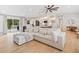 Spacious living area with large sectional sofa, hardwood floors, and access to the patio at 369 Arnold Mill Rd, Woodstock, GA 30188