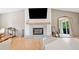 Bright living area with fireplace, large mirror, hardwood floors, and neutral color palette at 369 Arnold Mill Rd, Woodstock, GA 30188