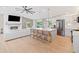 Spacious open-concept living area with modern fireplace and kitchen with stainless appliances at 369 Arnold Mill Rd, Woodstock, GA 30188