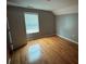 Bedroom with wood floors and a window with blinds at 4341 Savannah Ln, Atlanta, GA 30349