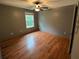A simple bedroom with wood floors and a single window at 4341 Savannah Ln, Atlanta, GA 30349