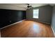 Large bedroom featuring wood floors, a fan, and a window at 4341 Savannah Ln, Atlanta, GA 30349