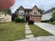 Charming two-story home features a well-manicured lawn and a two car garage at 4341 Savannah Ln, Atlanta, GA 30349