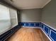 Empty room featuring wood floors, blue trim, and bright window at 4341 Savannah Ln, Atlanta, GA 30349