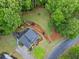 Aerial view of home on large lot with backyard patio and lush landscaping at 4592 Planters Hill Dr, Powder Springs, GA 30127