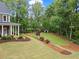 Expansive backyard featuring lush greenery, landscaping, and a storage shed at 4592 Planters Hill Dr, Powder Springs, GA 30127