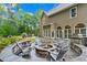Backyard patio with built-in kitchen, grill and fire pit with seating near the home's exterior at 4592 Planters Hill Dr, Powder Springs, GA 30127