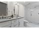 This modern bathroom has a glass-enclosed shower, double sinks, and great lighting at 4592 Planters Hill Dr, Powder Springs, GA 30127