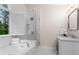 This bathroom features a large tub under a window with a glass-enclosed shower at 4592 Planters Hill Dr, Powder Springs, GA 30127
