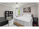 Well-lit bedroom featuring a ceiling fan, window with shutters, and hardwood floors at 4592 Planters Hill Dr, Powder Springs, GA 30127