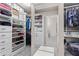 This large walk-in closet with well-organized shelving and an adjoining bathroom is ready to be filled at 4592 Planters Hill Dr, Powder Springs, GA 30127