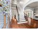 Bright foyer with hardwood floors, staircase, and elegant decor at 4592 Planters Hill Dr, Powder Springs, GA 30127