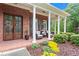 Inviting front porch with chairs, columns, and well-maintained landscaping at 4592 Planters Hill Dr, Powder Springs, GA 30127