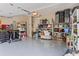 This well-organized garage features epoxy floors and ample storage on shelving at 4592 Planters Hill Dr, Powder Springs, GA 30127