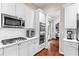 Galley kitchen showcasing stainless steel appliances and white shaker style cabinets at 4592 Planters Hill Dr, Powder Springs, GA 30127
