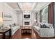 Elegant living room features a fireplace, coffered ceiling, and large windows at 4592 Planters Hill Dr, Powder Springs, GA 30127