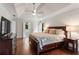 This is a large main bedroom with trey ceilings, hardwood floors, and bright natural light at 4592 Planters Hill Dr, Powder Springs, GA 30127