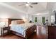 This is a large main bedroom with trey ceilings, hardwood floors, and bright natural light at 4592 Planters Hill Dr, Powder Springs, GA 30127