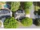 Aerial view of a home with a pool, mature trees, and a well-manicured yard in a desirable neighborhood at 5620 Preserve Cir, Johns Creek, GA 30005