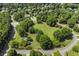 Aerial view of a neighborhood featuring well-maintained lawns, mature trees, and winding streets at 5620 Preserve Cir, Johns Creek, GA 30005