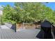 Back deck with a built-in grill, offering ample space for outdoor entertainment at 5620 Preserve Cir, Johns Creek, GA 30005