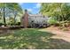 Expansive backyard with a well-maintained lawn, mature trees, and a deck, perfect for relaxing and entertaining at 5620 Preserve Cir, Johns Creek, GA 30005