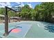 Community basketball court featuring multiple hoops, a green surface, and lights for evening play at 5620 Preserve Cir, Johns Creek, GA 30005