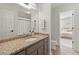 This bathroom features granite countertops and a view into the bedroom at 5620 Preserve Cir, Johns Creek, GA 30005
