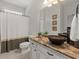 Bathroom with granite counter, bronze vessel sink and neutral tile flooring at 5620 Preserve Cir, Johns Creek, GA 30005