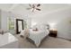 Main bedroom with neutral color palette, tray ceiling, and abundant natural light at 5620 Preserve Cir, Johns Creek, GA 30005