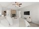 Bedroom featuring fireplace, television, ceiling fan, and tray ceilings at 5620 Preserve Cir, Johns Creek, GA 30005