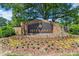 Stone entrance sign for Seven Oaks community featuring landscaping and mature trees at 5620 Preserve Cir, Johns Creek, GA 30005