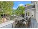 Outdoor dining on the deck features wood furnishings and view of the backyard at 5620 Preserve Cir, Johns Creek, GA 30005
