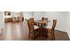 View of the dining area with hardwood floors and kitchen in background at 5620 Preserve Cir, Johns Creek, GA 30005