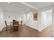 Hardwood floor dining area with a dart board and view of the stairs at 5620 Preserve Cir, Johns Creek, GA 30005
