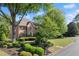 Beautiful two-story brick home with manicured landscaping and mature trees at 5620 Preserve Cir, Johns Creek, GA 30005