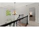 Bright foyer with chandelier, open staircase, and views of the front yard at 5620 Preserve Cir, Johns Creek, GA 30005