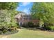 Well-kept brick home with beautiful landscaping, a green lawn, and mature trees, offering great curb appeal at 5620 Preserve Cir, Johns Creek, GA 30005