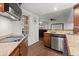 Open kitchen with granite countertops and stainless steel appliances at 5620 Preserve Cir, Johns Creek, GA 30005