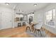 Bright kitchen with stainless appliances, white cabinets, pendant lights, and an adjacent breakfast nook at 5620 Preserve Cir, Johns Creek, GA 30005