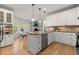 Updated kitchen with custom white cabinets, granite countertops, stainless steel appliances and breakfast nook at 5620 Preserve Cir, Johns Creek, GA 30005