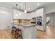 Bright kitchen with white cabinetry, granite countertops, stainless steel appliances, and a charming center island at 5620 Preserve Cir, Johns Creek, GA 30005