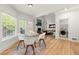 A dining area featuring an entrance to the laundry room with modern appliances and an open view to the living room at 5620 Preserve Cir, Johns Creek, GA 30005