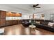 Large living area featuring a leather couch, built-in bar with cabinets and wine cooler, ideal for relaxation at 5620 Preserve Cir, Johns Creek, GA 30005